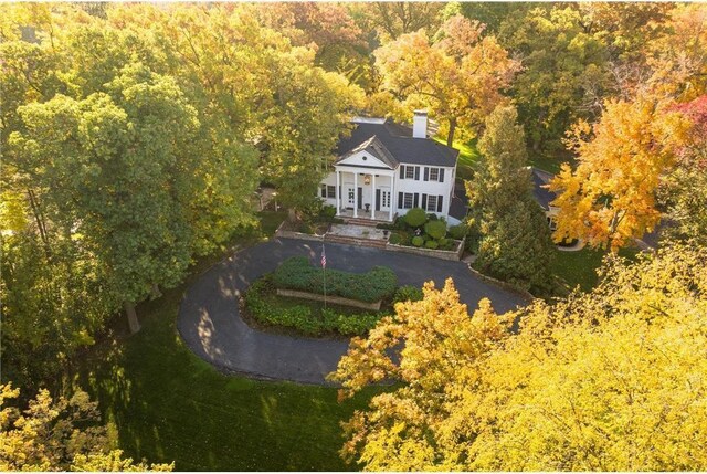 birds eye view of property with a view of trees