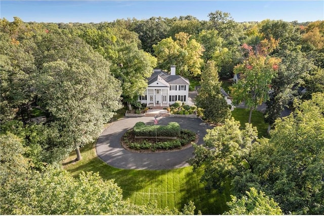 drone / aerial view with a wooded view