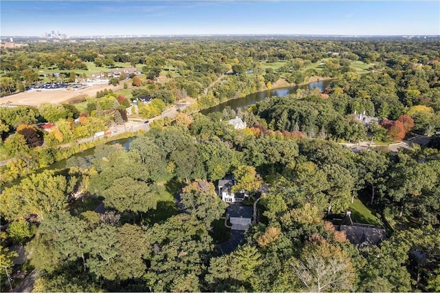 birds eye view of property with a water view and a forest view