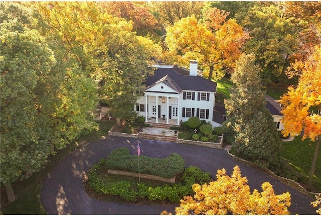 birds eye view of property with a wooded view