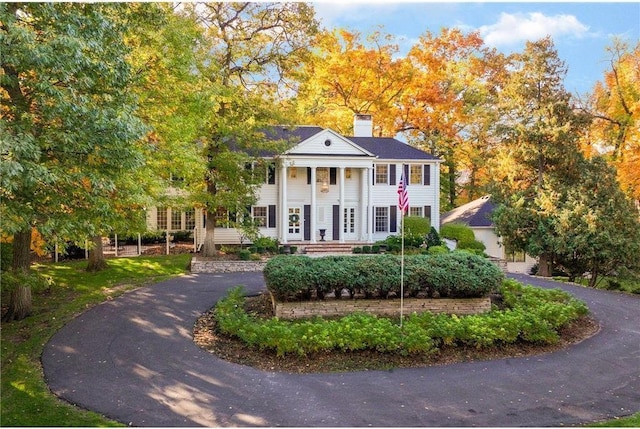 greek revival inspired property featuring a chimney