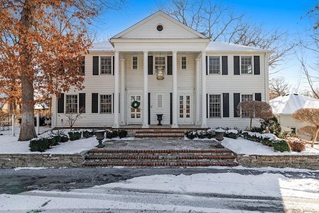 greek revival house with fence and a porch