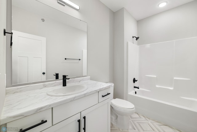 full bathroom featuring bathing tub / shower combination, vanity, and toilet