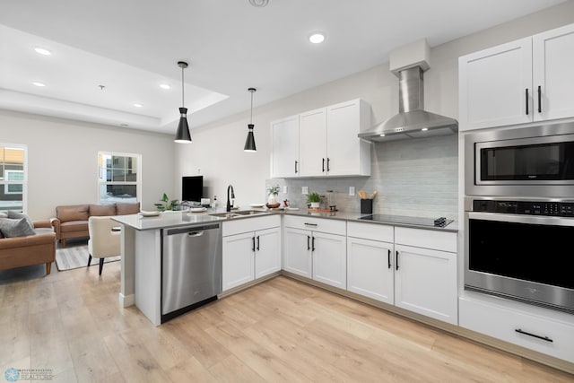 5861 41st St S, Fargo, ND 58104 - kitchen with appliances with stainless steel finishes, wall chimney range hood, open floor plan, backsplash, and recessed lighting