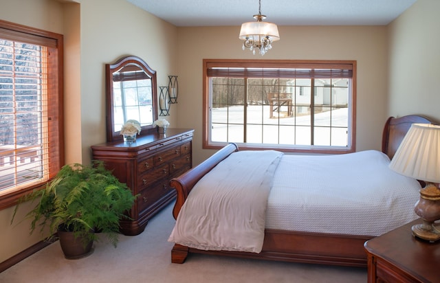 carpeted bedroom featuring a notable chandelier