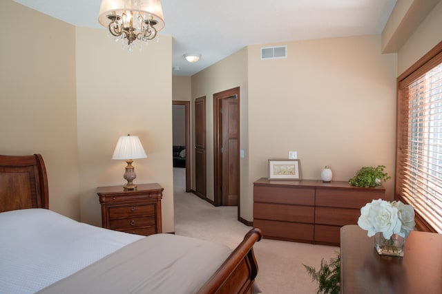 bedroom with visible vents, light colored carpet, and an inviting chandelier