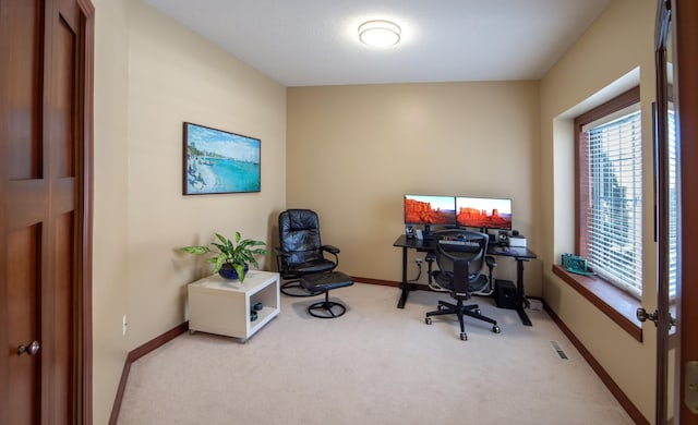 office area with visible vents, baseboards, and carpet