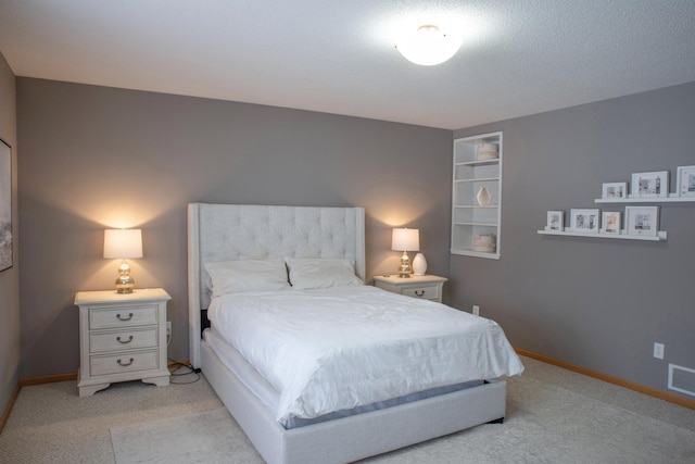 bedroom featuring light carpet, visible vents, and baseboards