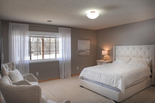 carpeted bedroom featuring a textured ceiling and baseboards