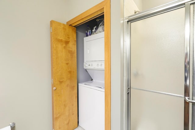 clothes washing area with stacked washer and dryer