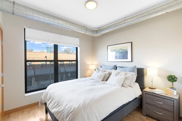 bedroom with light hardwood / wood-style flooring