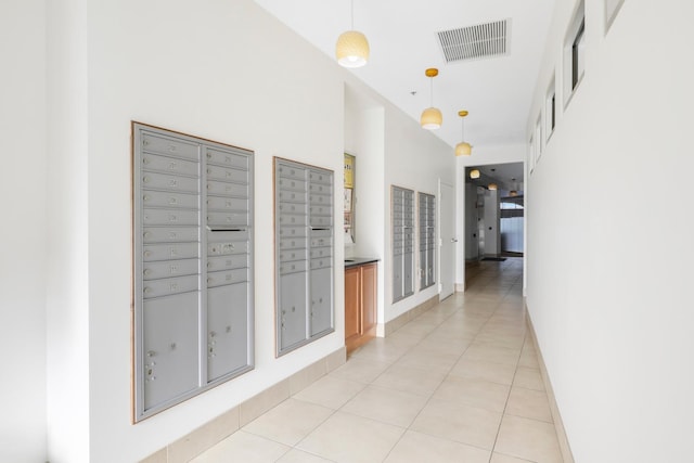 corridor featuring light tile patterned flooring and mail boxes