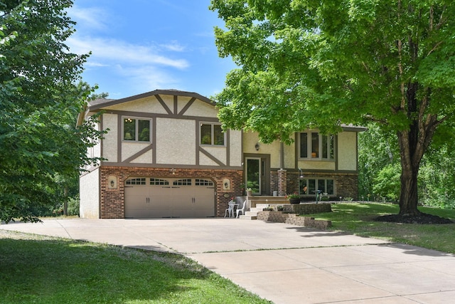 4879 Mayelin Ave NE, Saint Michael, MN 55376 - view of front facade with stucco siding, a garage, concrete driveway, and a front lawn