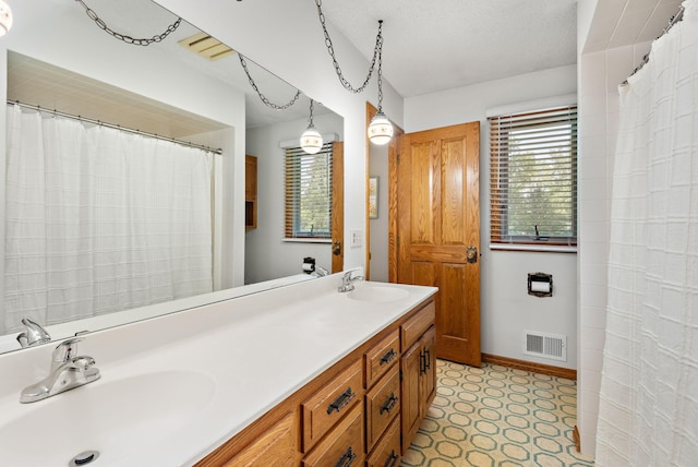 4879 Mayelin Ave NE, Saint Michael, MN 55376 - full bath with double vanity, tile patterned floors, and a shower with curtain