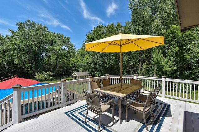 4879 Mayelin Ave NE, Saint Michael, MN 55376 - deck featuring outdoor dining space, an outbuilding, and view of scattered trees