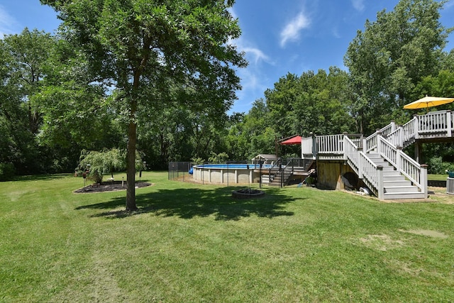 4879 Mayelin Ave NE, Saint Michael, MN 55376 - view of grassy yard with a deck, stairs, an outdoor pool, and view of scattered trees