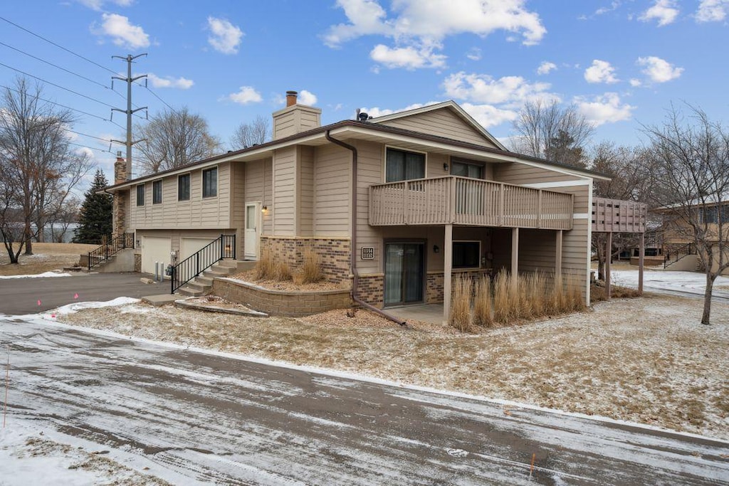 view of front of home featuring a garage and a balcony