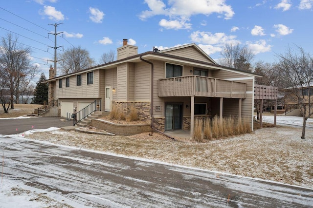 view of front of home featuring a garage and a balcony