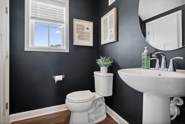 bathroom featuring sink, hardwood / wood-style flooring, and toilet