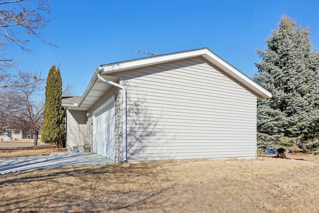 view of home's exterior featuring concrete driveway