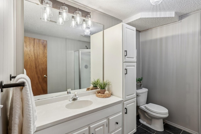 bathroom with a stall shower, toilet, tile patterned flooring, a textured ceiling, and vanity