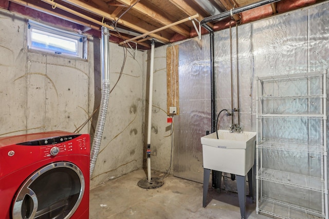 basement featuring washer / clothes dryer and a sink