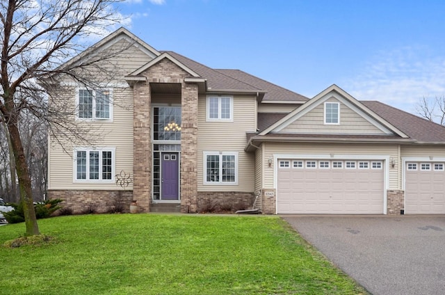 view of front of house with driveway, a garage, roof with shingles, a front lawn, and brick siding