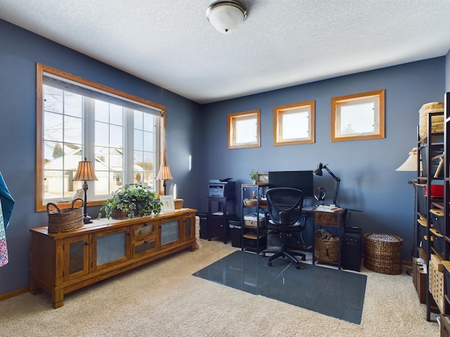 office featuring light carpet, a textured ceiling, and baseboards