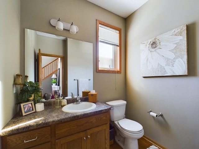 bathroom featuring toilet and vanity