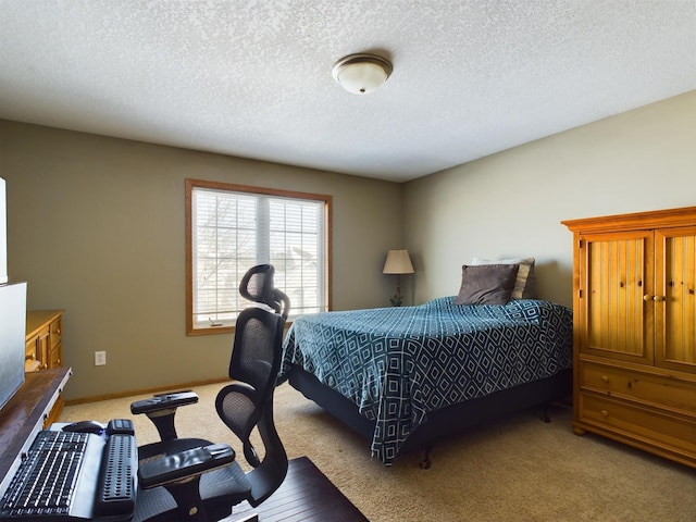 bedroom featuring light carpet, baseboards, and a textured ceiling