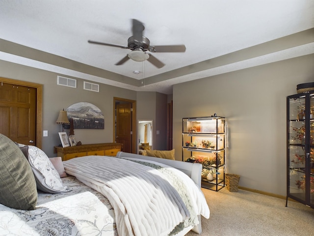 bedroom with baseboards, ceiling fan, visible vents, and light colored carpet