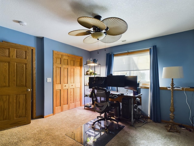 office space featuring a textured ceiling, ceiling fan, carpet flooring, and baseboards