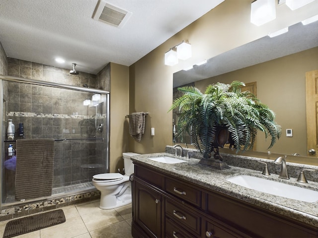 bathroom with a stall shower, visible vents, a sink, and double vanity