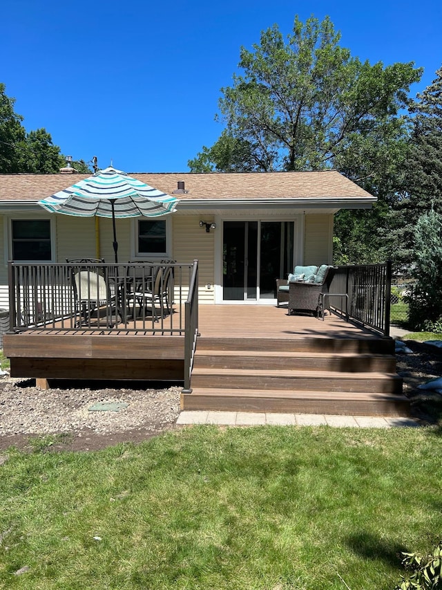 rear view of property with a wooden deck, a lawn, and outdoor lounge area