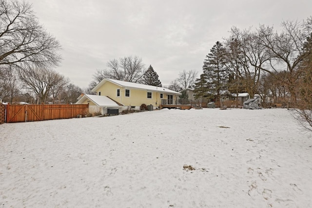 snow covered house with a deck