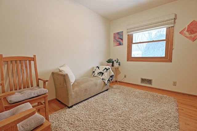 sitting room with wood-type flooring