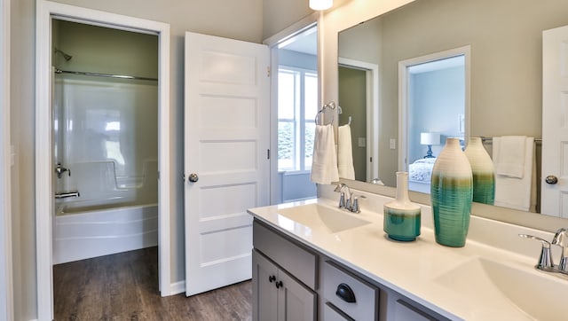 bathroom featuring vanity, hardwood / wood-style flooring, and bathtub / shower combination