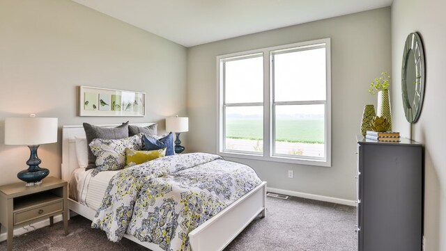 bedroom with a water view and carpet floors