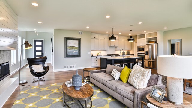 living room with hardwood / wood-style flooring and sink