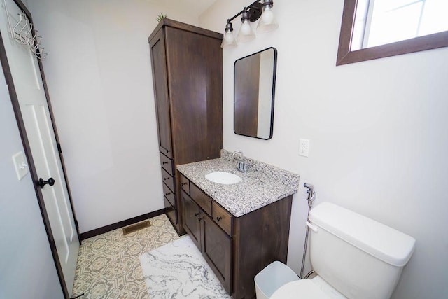 bathroom with vanity and toilet