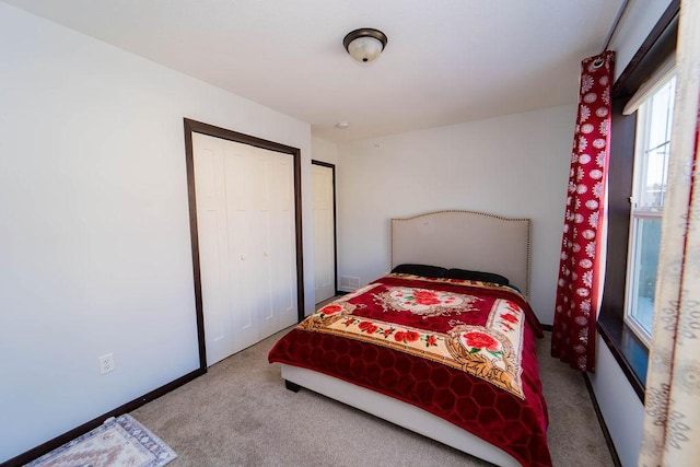 carpeted bedroom with a closet