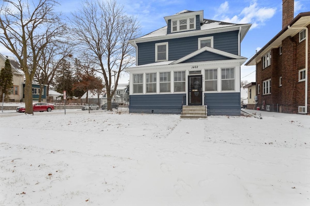 view of front of property with a sunroom