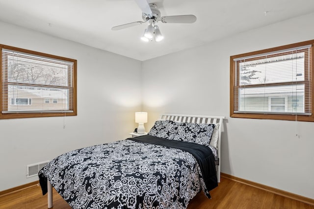 bedroom with hardwood / wood-style flooring and ceiling fan