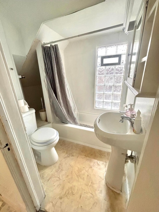 bathroom with shower / tub combo and toilet