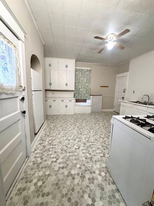 kitchen featuring white cabinetry, white appliances, ceiling fan, and sink