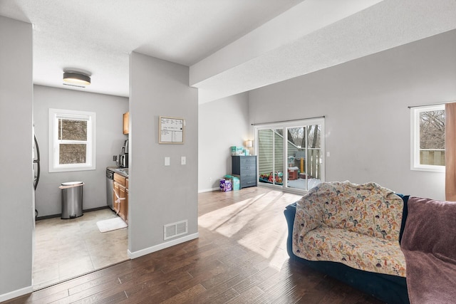 living room featuring wood-type flooring and a textured ceiling