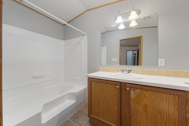 bathroom with vanity, tile patterned flooring, and washtub / shower combination