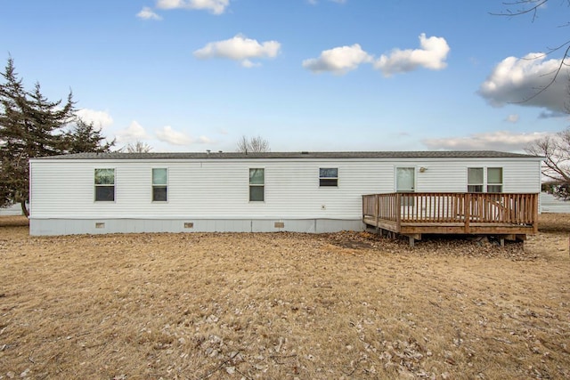 rear view of property with a yard and a deck