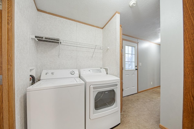 laundry area featuring crown molding, independent washer and dryer, light carpet, and a textured ceiling