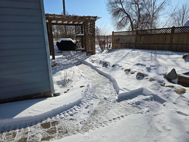 snowy yard featuring a pergola